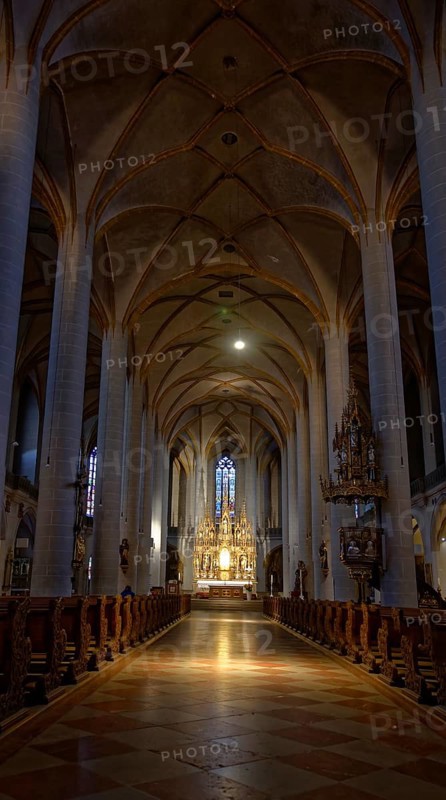 Rays of sunlight flood the quiet interior of St Martin's Basilica, Amberg, Upper Palatinate, Bavaria, Germany, Europe