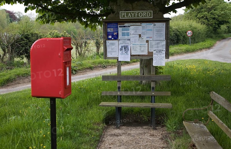 Small rural settlement services comprising of community noticeboard, wooden benches, post box, Playford, Suffolk, England, United Kingdom, Europe