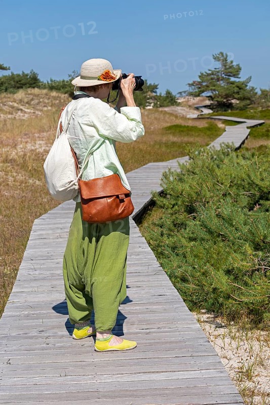 Woman photographed, wooden footbridge, trees, pine trees, circular hiking trail, nature reserve, Darßer Ort, Born a. Darß, Mecklenburg-Vorpommern, Germany, Europe