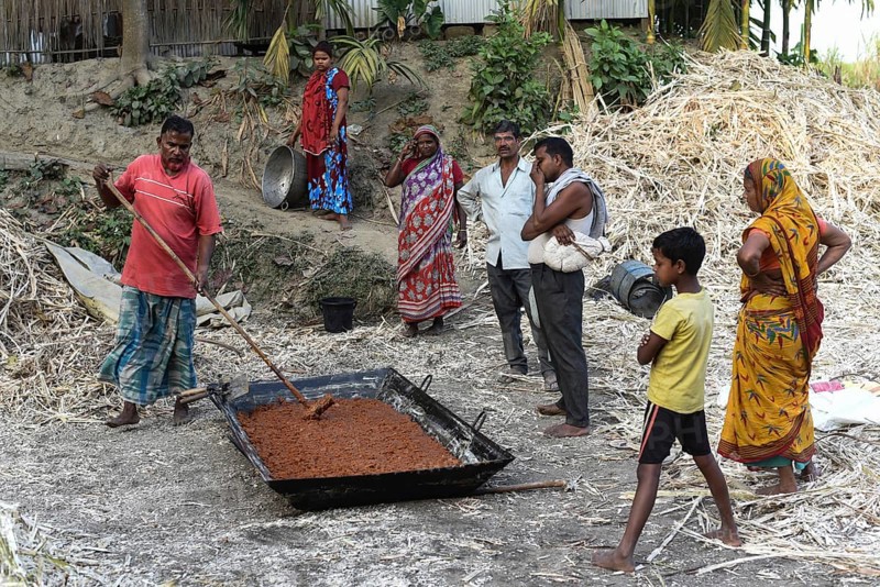 Workers making Gur (jaggery) in a village on December 10, 2021 in Barpeta, Assam, India. Gur (jaggery) is a natural product of sugarcane, makes from raw, concentrated sugarcane juice, consumed in the Indian Subcontinent and Southeast Asia