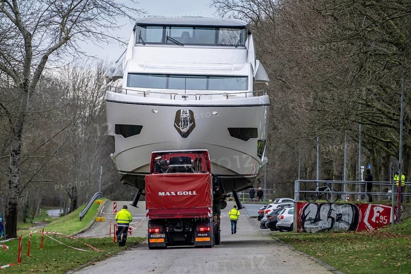 Craning the €6.3 million Sunseeker 88Y motor yacht, weighing 82 tonnes, in preparation for the world's largest water sports trade fair, Boot in Düsseldorf, luxury yachts are driven across the Rhine to the trade fair and brought ashore with the help of the Big Willi ship crane and transported to the exhibition halls on a low-loader, North Rhine-Westphalia, Germany, Europe
