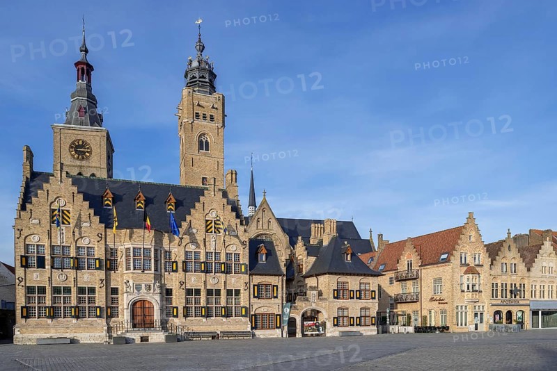 Market square showing town hall with belfy and St Nicholas Church tower, rebuilt after WWI in the city Diksmuide, Dixmude, West Flanders, Belgium, Europe