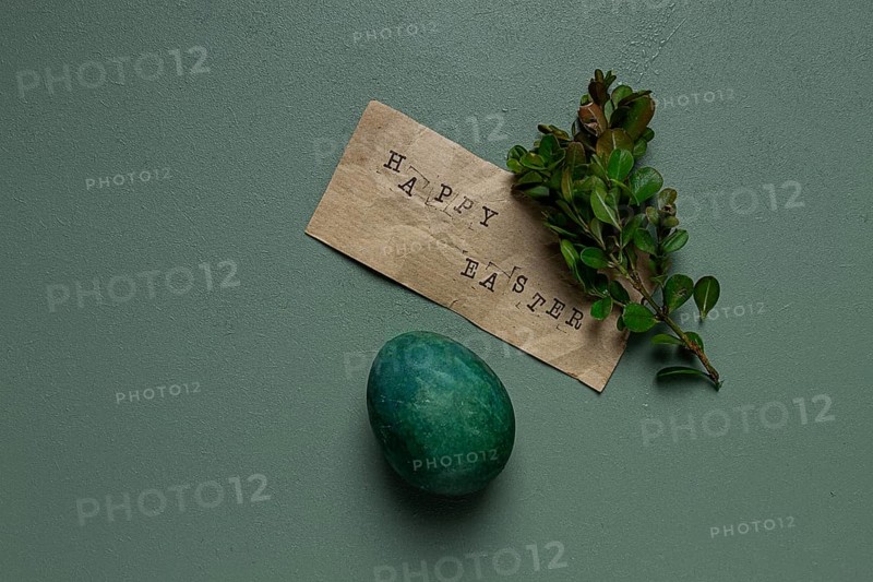 Easter card, green egg, boxwood branch, typewritten text, happy easter