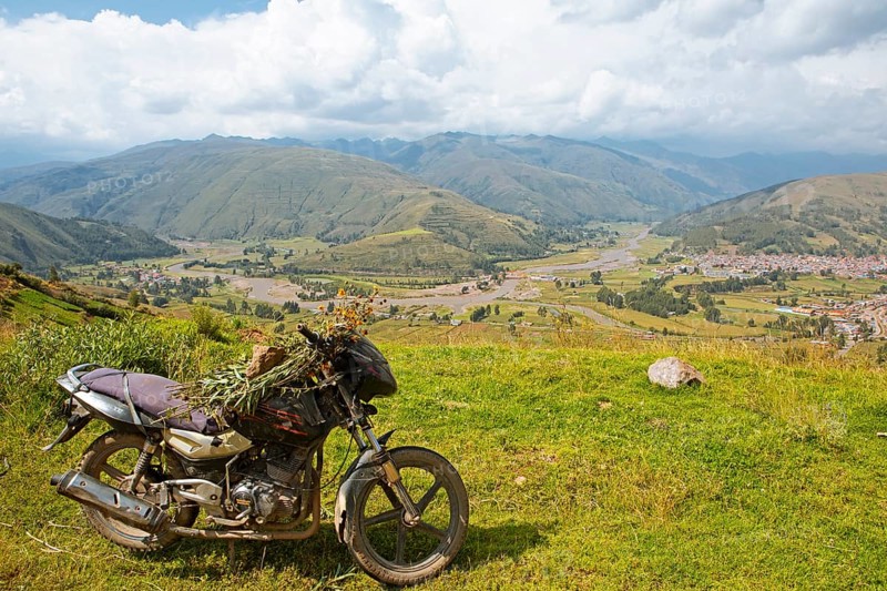 View of the Combapata district and the Rio Vilcanota in the Andean highlands, in front a motorbike, Canchis province, Peru, South America
