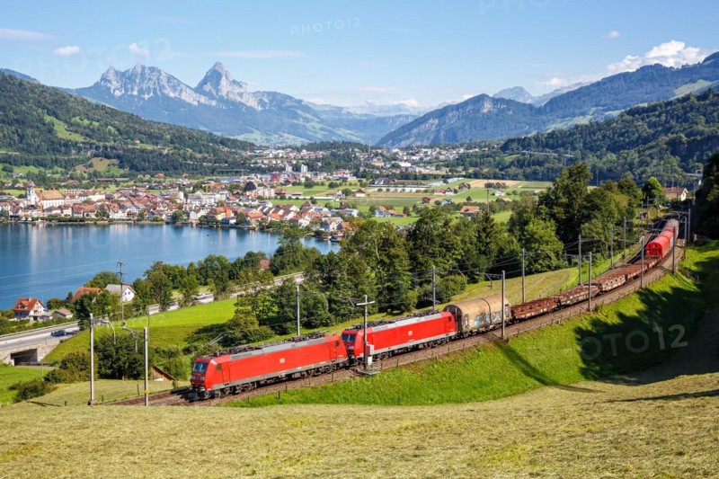 DB Cargo railway goods train on the Großer Mythen mountain on Lake Zug in the Alps in Arth, Switzerland, Europe