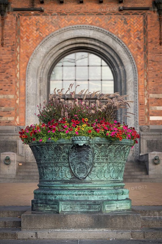 Flowers in a large bronze cauldron, entrance to City Hall in the National Romantic style by Martin Nyrop, City Hall Square or Rådhuspladsen, Copenhagen, Denmark, Europe