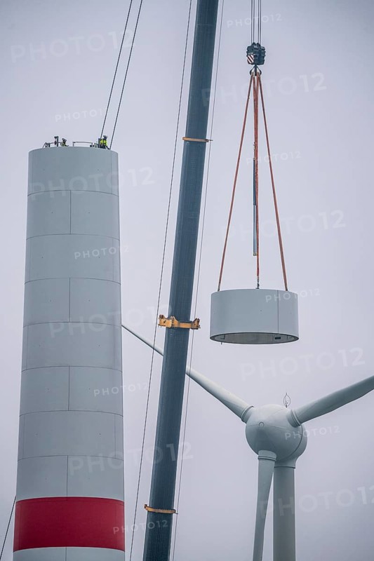 Construction of the tower of a wind power plant in a wind farm near Issum, 9 older wind turbines from the manufacturer Enercon (model series E-58) at the rear right, which have been in operation for over two decades, will be replaced by a total of four Enercon E-160 turbines, under construction, with a total output of 22 megawatts, Lower Rhine, North Rhine-Westphalia, Germany, Europe