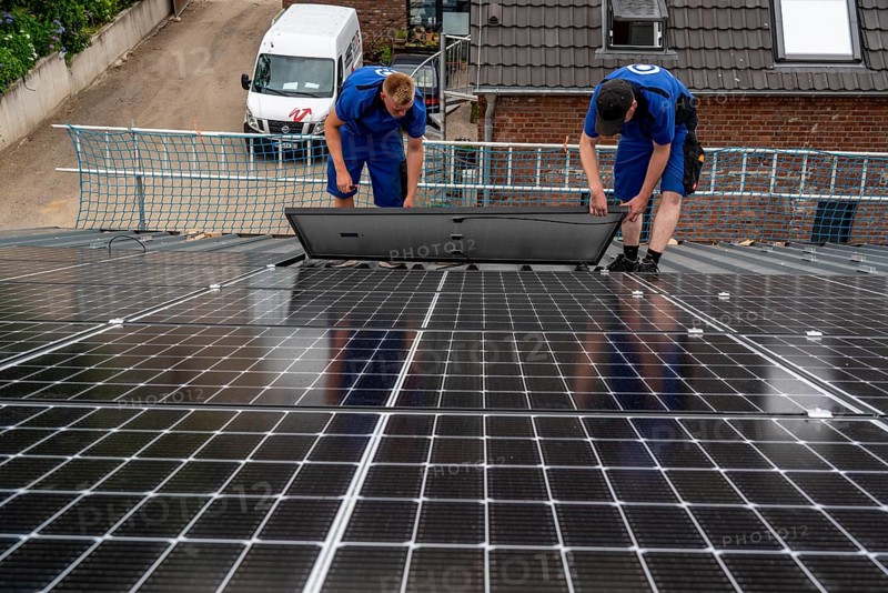 Installation of solar modules on the roof of a barn on a farm, over 240 photovoltaic modules are installed on the roof, North Rhine-Westphalia, Germany, Europe