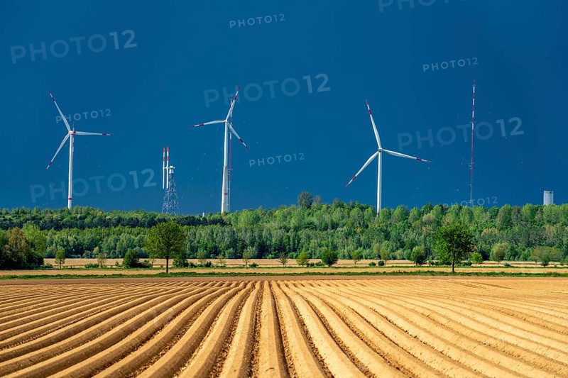 Wind turbines on the Grevenbroich wind test field, dark rain clouds, in the Rhenish lignite mining area, field with potato ridges, near Grevenbroich, North Rhine-Westphalia, Germany, Europe