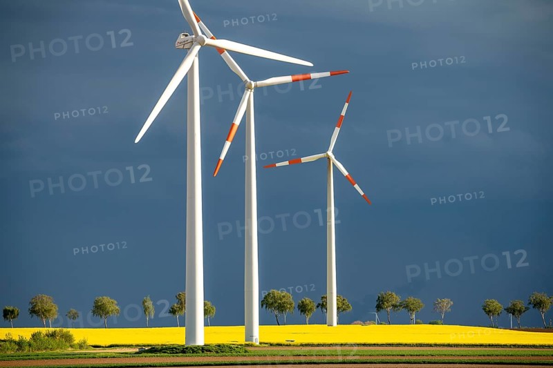 Wind turbines on a rape field, dark rain clouds, in the Rhenish lignite mining area, near Erkelenz-Holzweiler