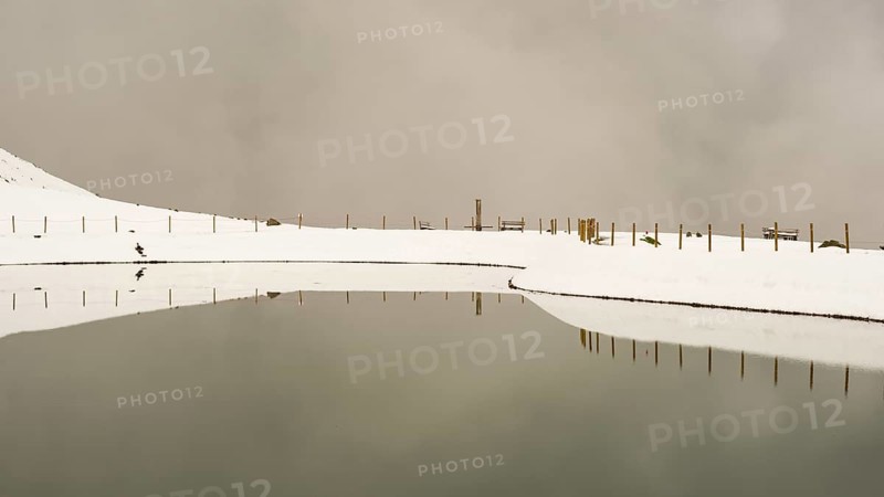 After snowfall in May: Riezler Alpsee, an artificial lake, snow pond, feeds the snow cannons that completely cover the slopes of the Fellhorn and Kanzelwand cable cars with snow, Allgäu Alps, Vorarlberg, Austria, Europe