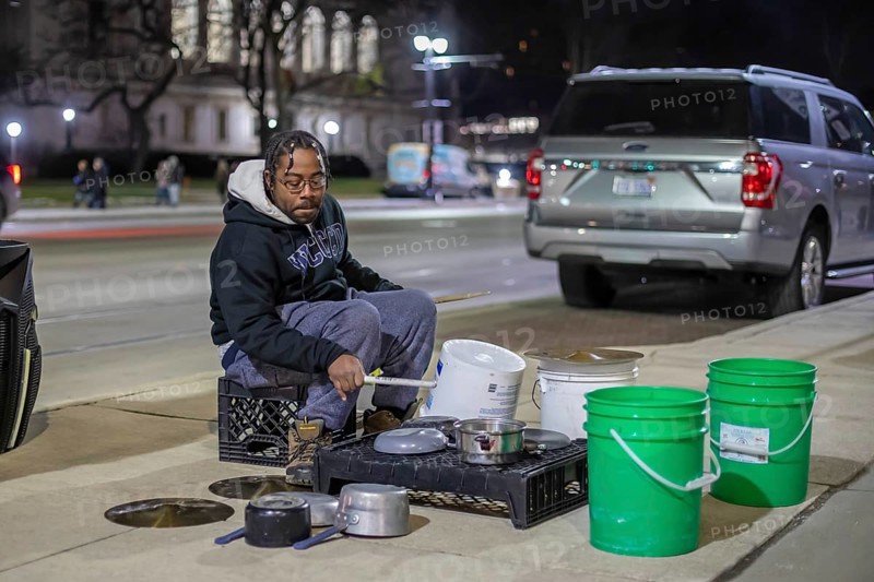 Detroit, Michigan - A street musician performs on his pots and pans on Noel Night. The annual event at the beginning of the holiday season in Detroit features open houses by arts and cultural institutions, churches, and small businesses.