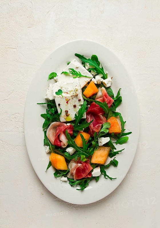 Salad, melon with prosciutto, arugula, and cheese, summer salad, vegetarian, homemade, no people