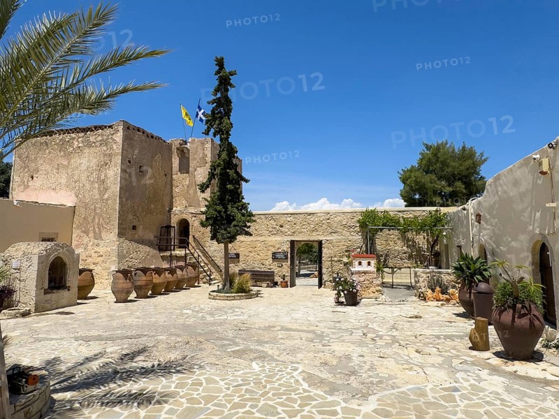 View of the inner courtyard of Odigitria Monastery left in the background large clay pots behind historic monastery defence tower defence tower Xopatera Tower 19th century tower of Xopateras Unesco Site Orthodox Greek Orthodox Monastery Moni Odigitria, Festos, Crete, Greece, Europe