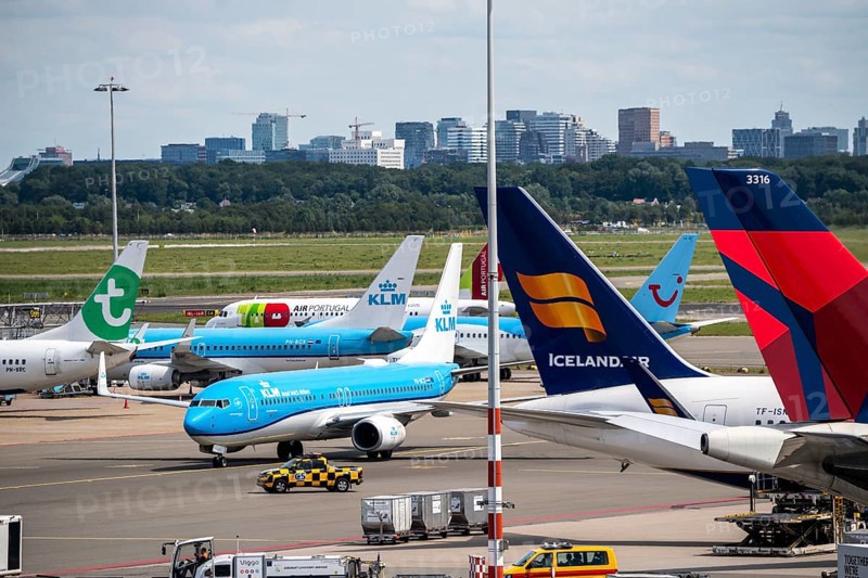 Amsterdam Schiphol Airport, aircraft at the terminal, Gates D, check-in, apron, skyline of Amsterdam city centre, Netherlands