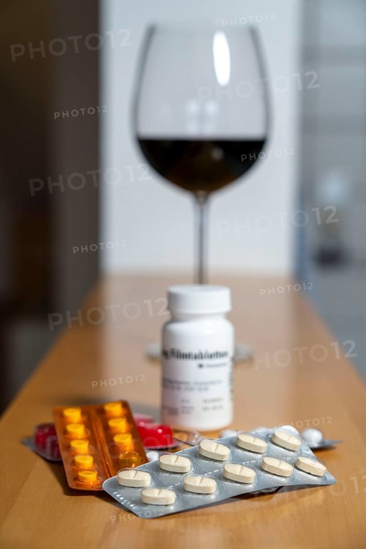 Symbolic image of alcohol and medication, you should not take medicine, pills, tablets with alcohol, the effect is intensified or the medicine does not work properly