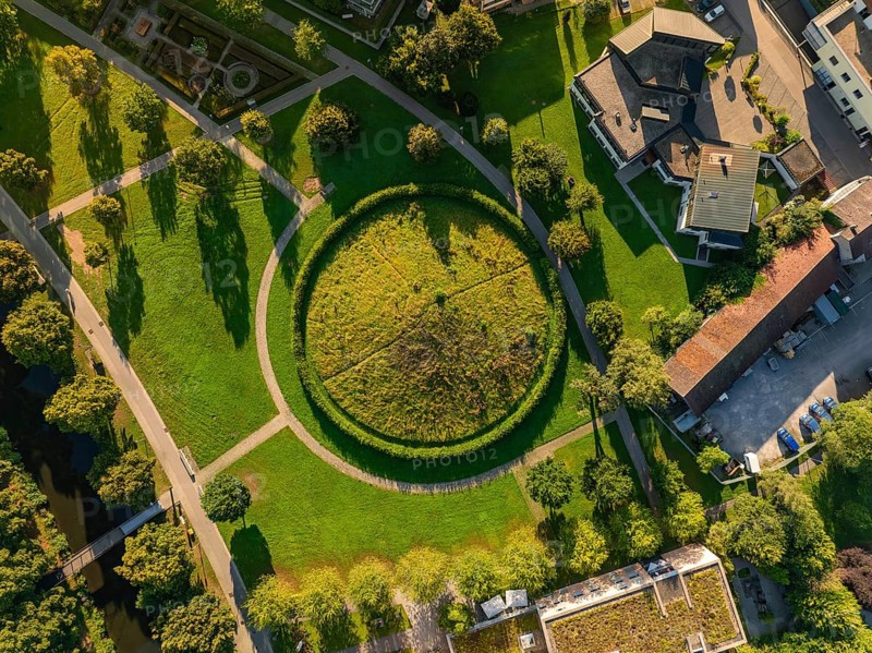 Aerial view of a green Celtic burial mound with circular path surrounded by houses and trees, Nagold, Black Forest, Germany, Europe