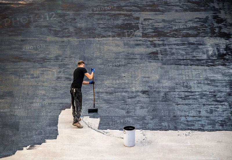 Construction site, application of a bitumen coating to a concrete ceiling, preparation for waterproofing, with bitumen membranes applied thermally, Duisburg, Germany, Europe