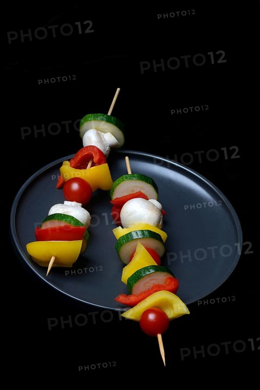 Colourful vegetable skewers on a plate, barbecue skewers