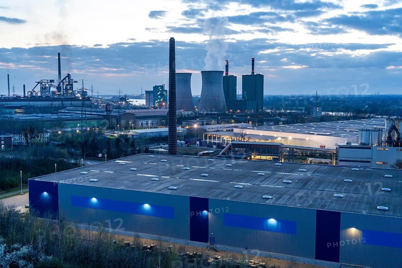 Logistics site, warehouse in Duisburg Wanheim, Angerhausen, in the background the HKM steelworks, with blast furnaces and power plant North Rhine-Westphalia, Germany, Europe