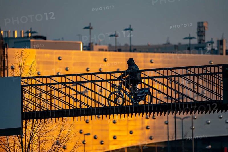 Cyclist on a bridge over Segerothstraße, in Essen, behind Limbecker Platz shopping centre
