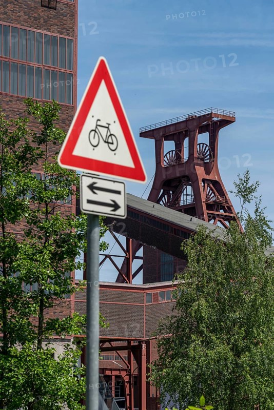 Cycling in the Ruhr area, at the Zollverein Coal Mine Industrial Complex World Heritage Site, double trestle winding tower shaft XII, Essen, North Rhine-Westphalia, Germany, Europe