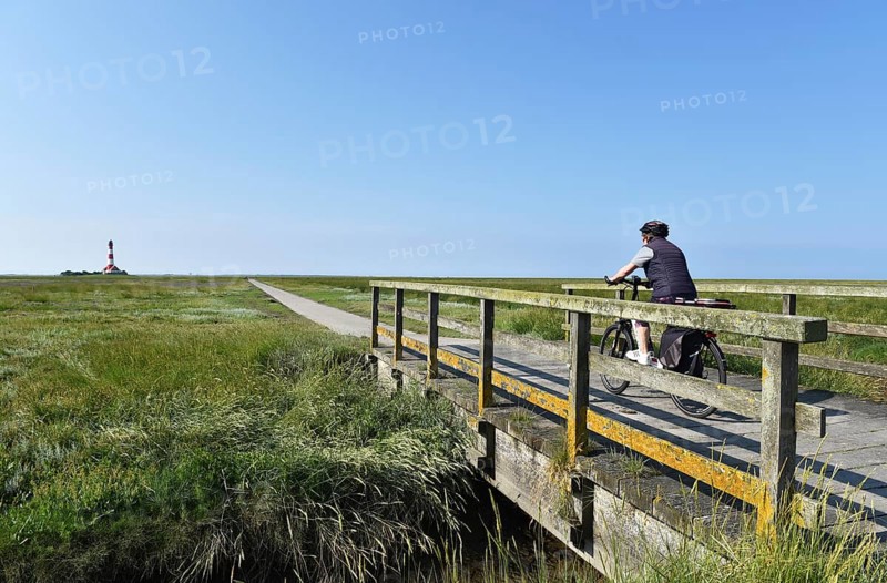 Cycling at the Westerheversand lighthouse, Schleswig-Holstein, Germany, Europe