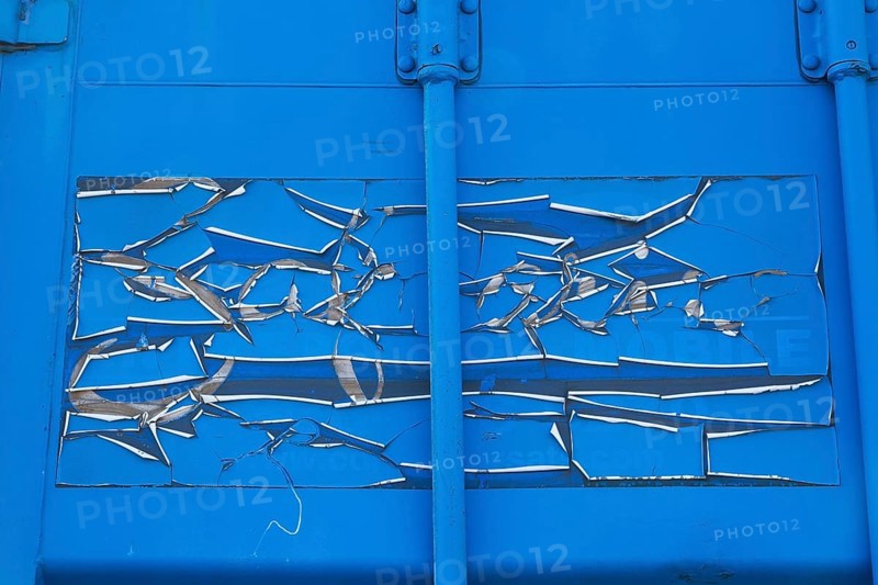 Close-up of cracked and peeling blue paint on metal shipping container, Quebec, Canada, North America