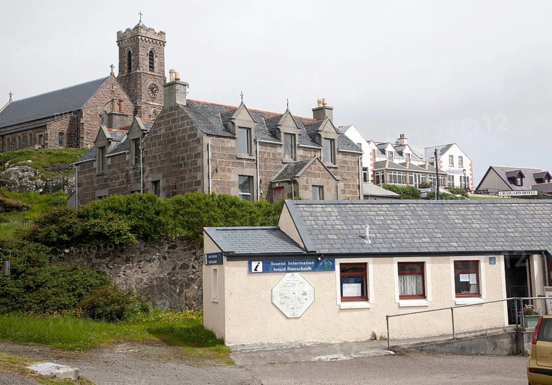 Tourist Information office, houses, hotel and church in Castlebay, Barra, Outer Hebrides, Scotland, UK
