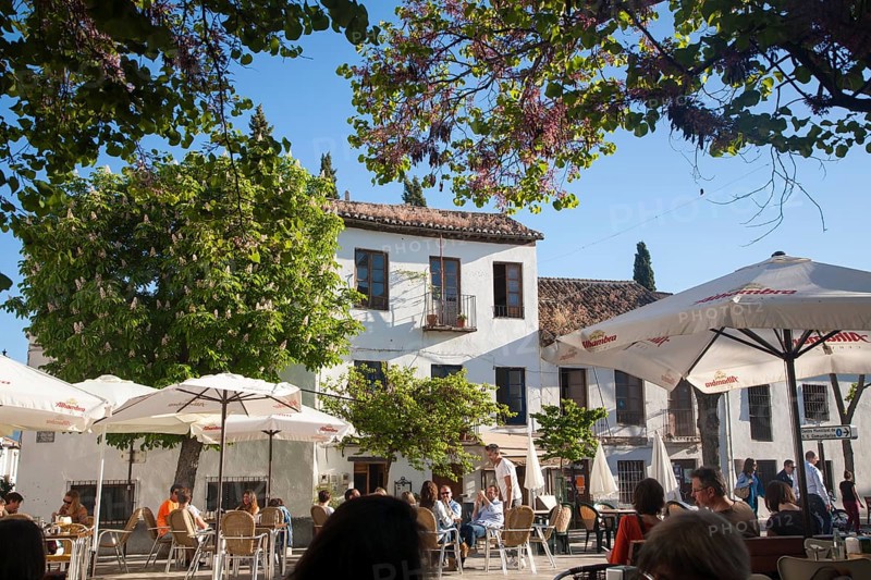People sitting outside cafes historic square Placeta de San Miguel Bajo in the Albaicin district, Granada, Spain, Europe