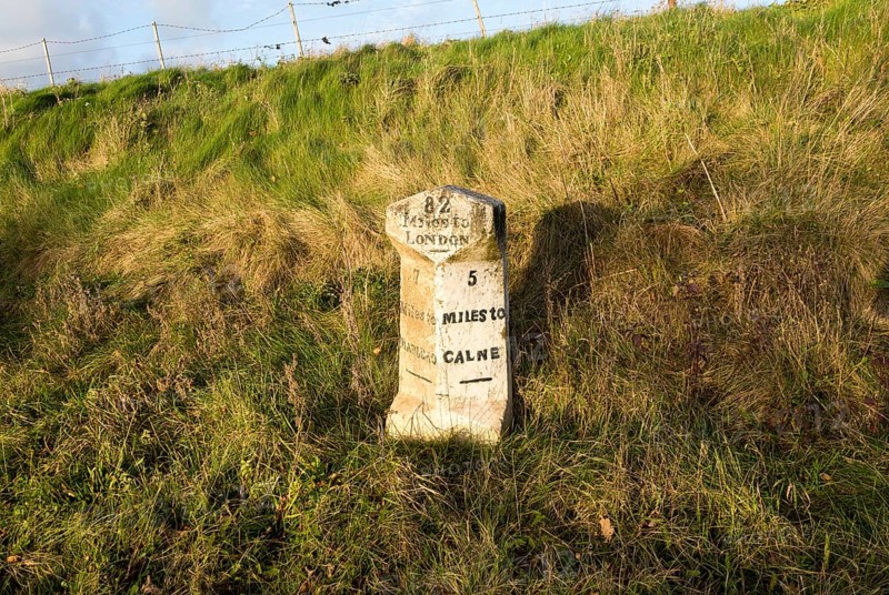 Old milestone road marker on A4 road Beckhampton, Wiltshire, England, UK