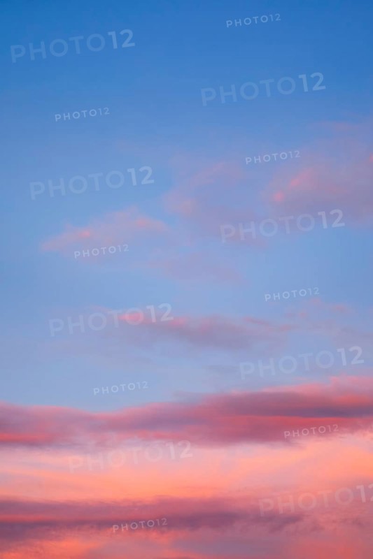 Blue sky with pink-coloured clouds at sunset
