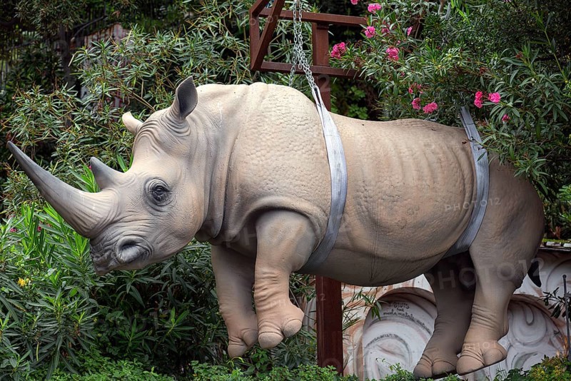 Replica rhinoceros hanging on chains, work of art in the harbour of Portofino Italy