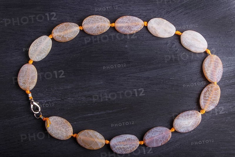 Dragon vein agate colored beads on a black background. top view, close up