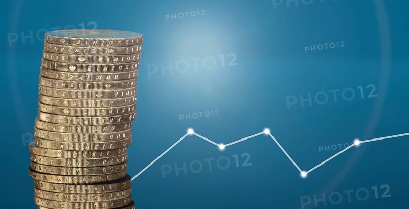 Stacked euro coins against a blue background