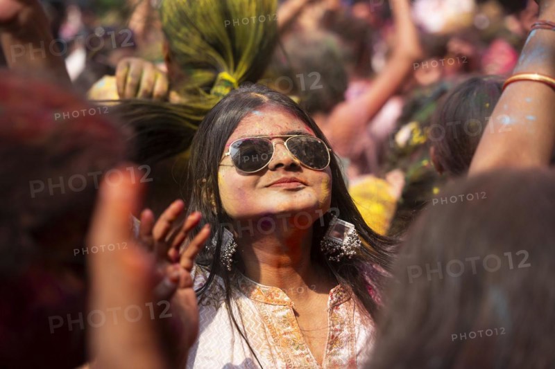 A girl dancing in the beat of music as she celebrate Holi on a street, the Hindu spring festival of colours on March 25, 2024 in Guwahati, Assam, India. Holi, also known as the Festival of Colors or the Festival of Spring, is one of the most vibrant and joyous festivals in India