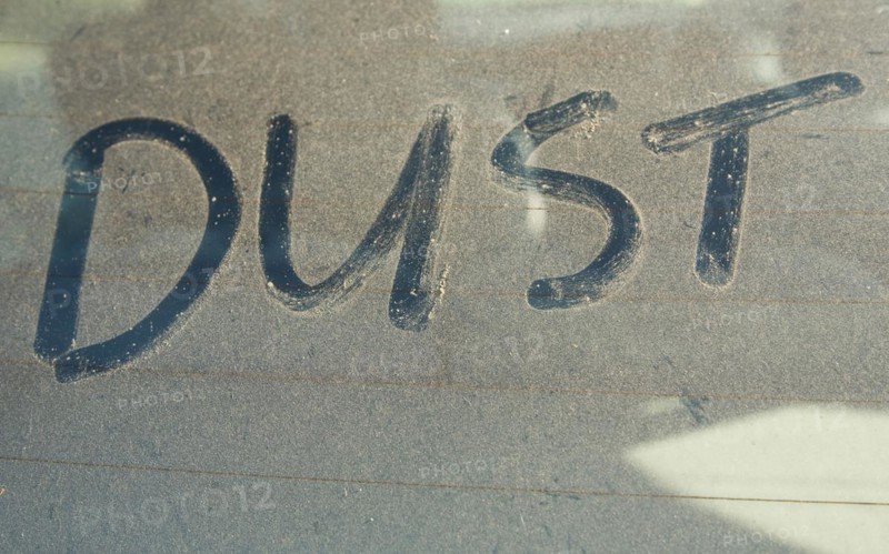 The word 'DUST' written on car rear windscreen following Saharan sand deposited in England by strong south easterly winds
