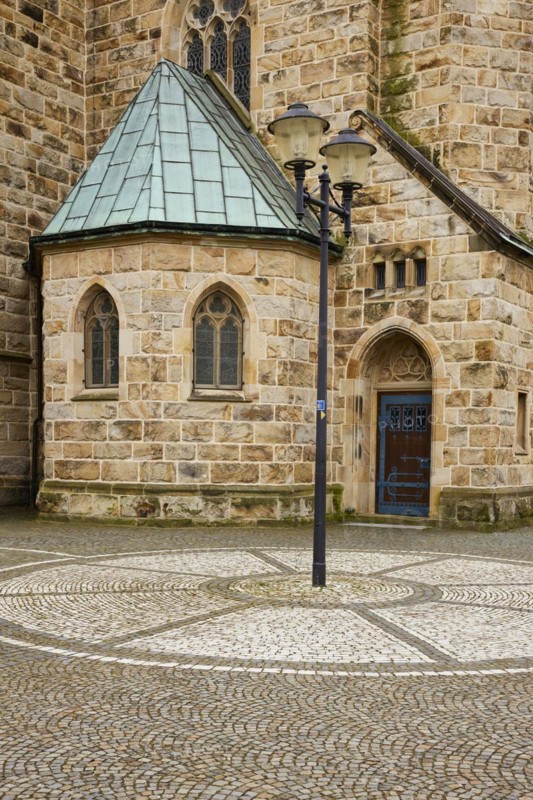 Cobblestones and lantern with part of St Laurentius Church in Warendorf, Warendorf district, North Rhine-Westphalia, Germany, Europe