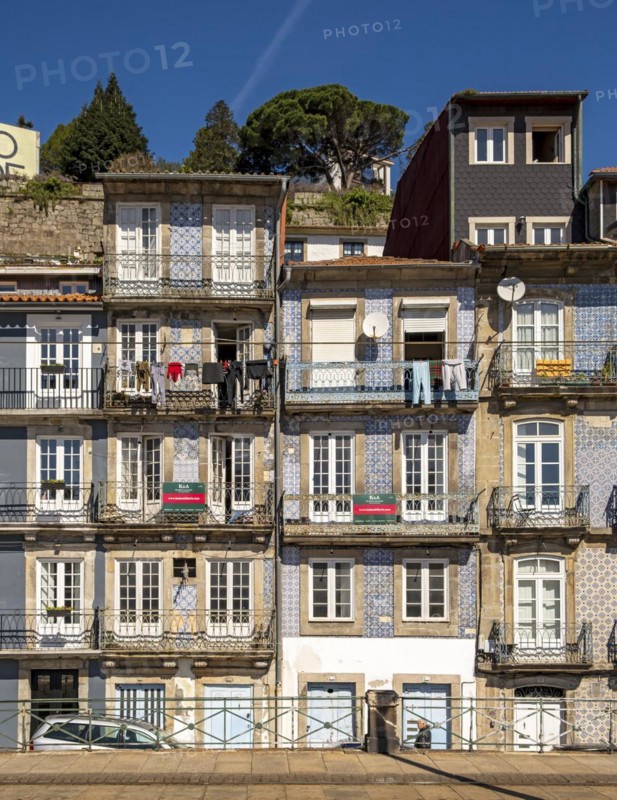 Front facades of narrow houses in the historic center near the Douro river in Porto, Portugal, Europe