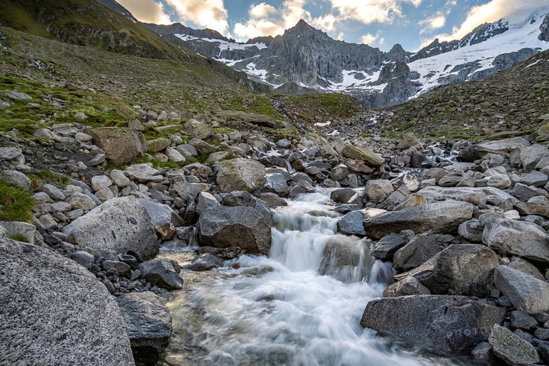 Mountain stream Furtschaglbach at sunrise, long exposure, rocky mountains behind, summit Furtschaglspitze with glacier Furtschaglkees, Furtschaglhaus, Berliner Höhenweg, Zillertal, Tyrol, Austria, Europe