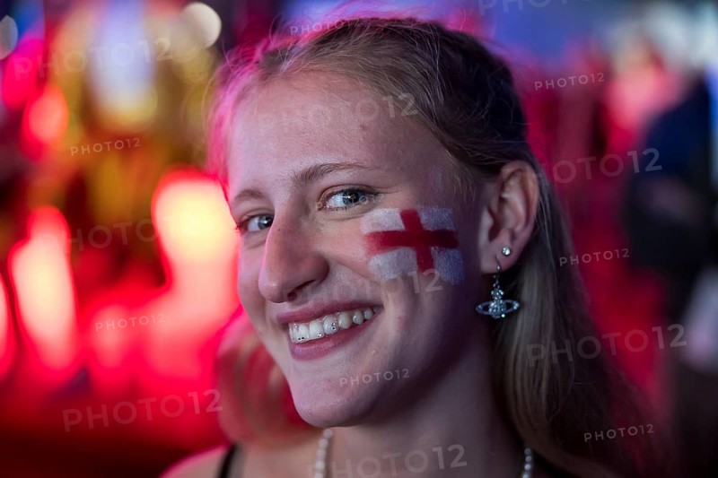 Fan of the English team with a flag on his cheek at the Adidas fan zone at the Bundestag during the final match between Spain and England at the European Football Championship, Berlin, 14 July 2024