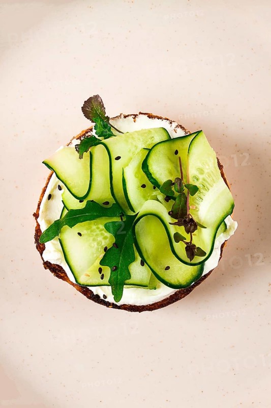 Sandwich, white bread with cream cheese, and sliced cucumber, breakfast, top view, no people, on a beige table