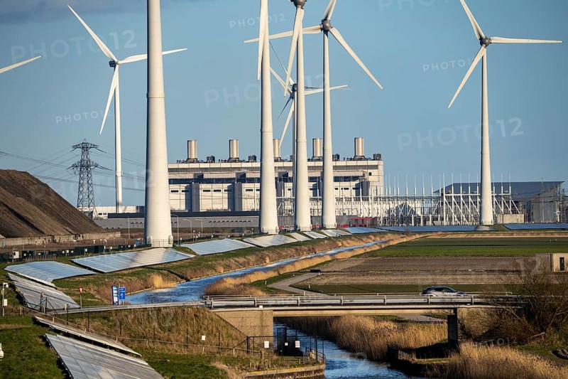 Solar park on the Slaperdijk dyke near the Eemshaven, test project, 17, 000 solar modules were installed over a good 5 km, the Netherlands has over 22, 000 km of dyke line, here it is being tested whether such an installation is successful and can be expanded, wind farm, behind the Eemscentrale gas and steam power station, Groningen, Netherlands