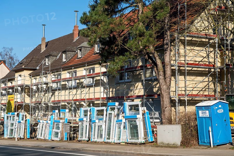 Energy-efficient refurbishment of residential buildings, older apartment block is scaffolded, gets thermal insulation and new windows, Germany, Europe