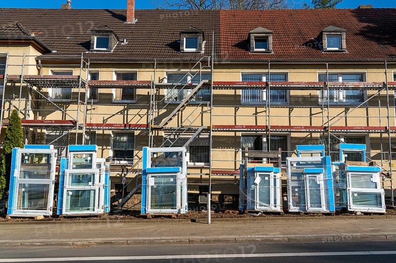 Energy-efficient refurbishment of residential buildings, older apartment block is scaffolded, gets thermal insulation and new windows, Germany, Europe