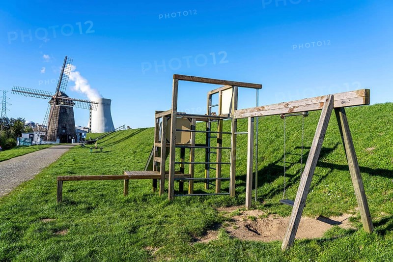 The Doel nuclear power plant on the Scheldt, one of two nuclear power plants in Belgium, consists of three operating units, each with a pressurised water reactor, as well as a decommissioned unit, historic Scheldemolen, windmill on the Scheldt dike, Antwerp, Belgium, Europe
