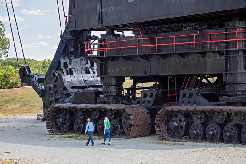 West Mineral, Kansas, Two people walk past the crawlers on Big Brutus, the world's largest electric shovel. The machine was built by Bucyrus-Erie for the Pittsburg and Midway coal mining company. It ran 24 hours a day from 1963 to 1974. It is now a tourist attraction