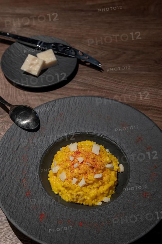 Elegant Plate with Risotto alla Milanese with Saffron and Parmesan Cheese in Lugano, Ticino, Switzerland, Europe