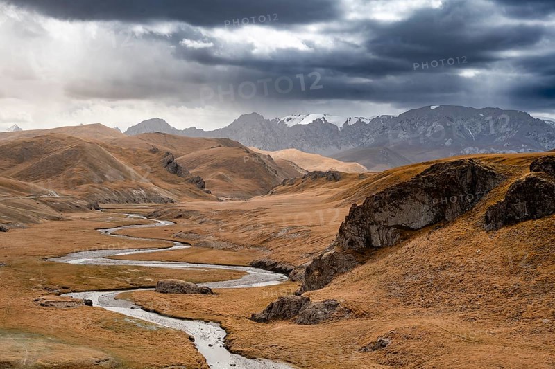 River in front of mountain landscape with yellow meadows, Kol Suu River and mountain peaks, Keltan Mountains, Sary Beles Mountains, Tien Shan, Naryn Province, Kyrgyzstan, Asia