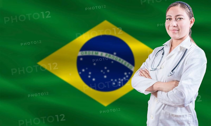Female doctor on Brazil flag. Doctor with crossed arms on Brazilian flag. Brazilian Health and Care concept